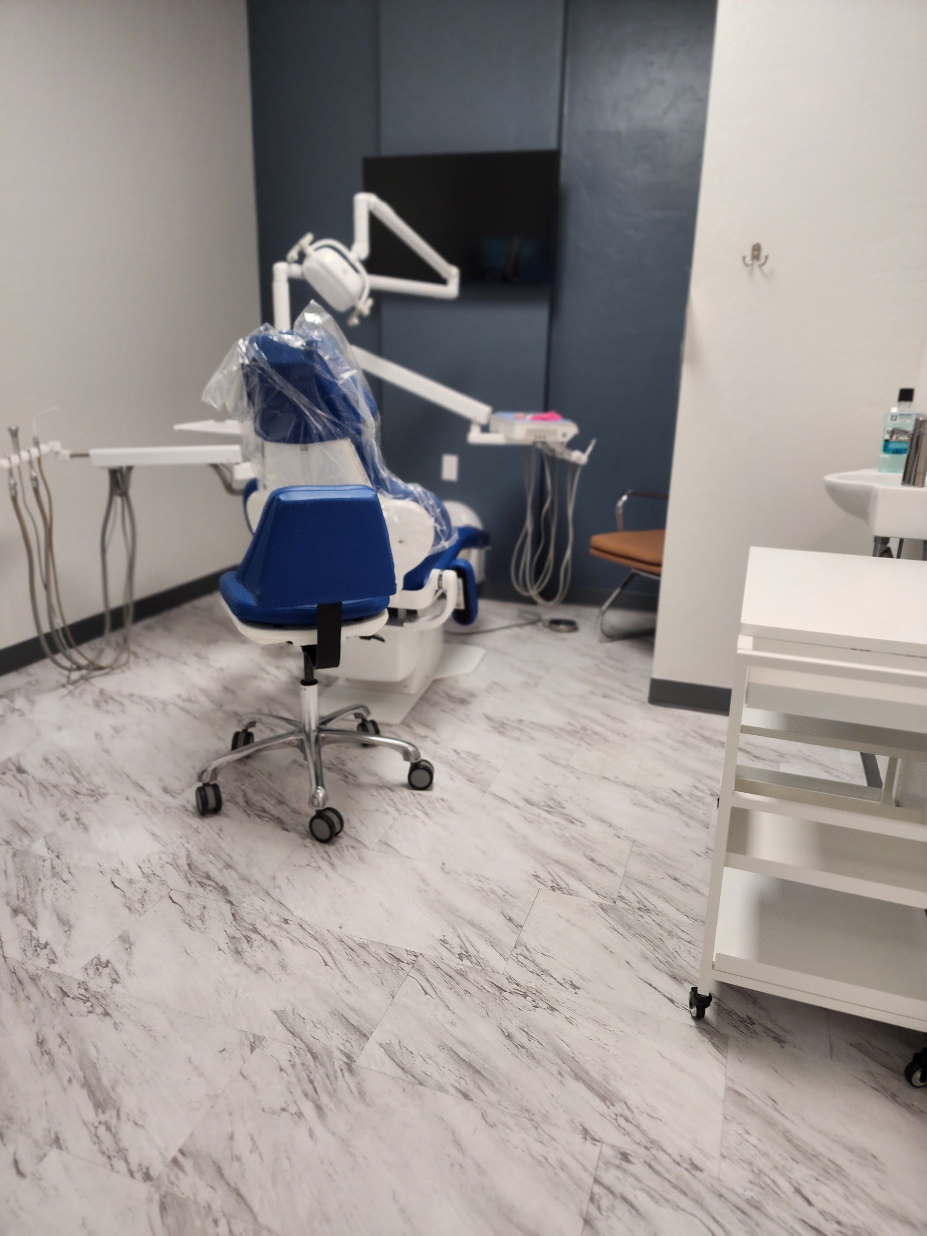 A treatment room with the chair and overhead light